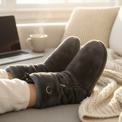 Feet in CozyStep heated slipper boots resting on a knit blanket in a home office